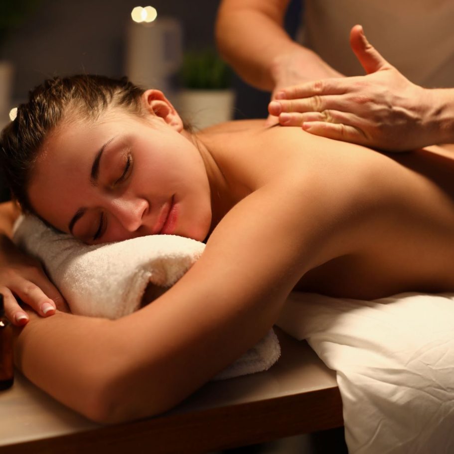 Woman receiving a relaxing Swedish back massage at Divine Lotus massage salon in Wolverhampton