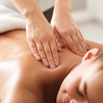 Woman receiving a relaxing Swedish back massage at Divine Lotus massage salon in Wolverhampton